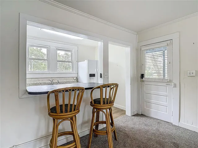 a kitchen with granite countertop white cabinets and refrigerator