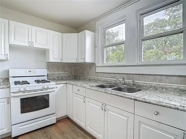 a kitchen with a sink cabinets and window