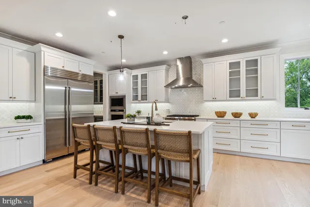 a kitchen with granite countertop a center island stainless steel appliances cabinets and a counter top space