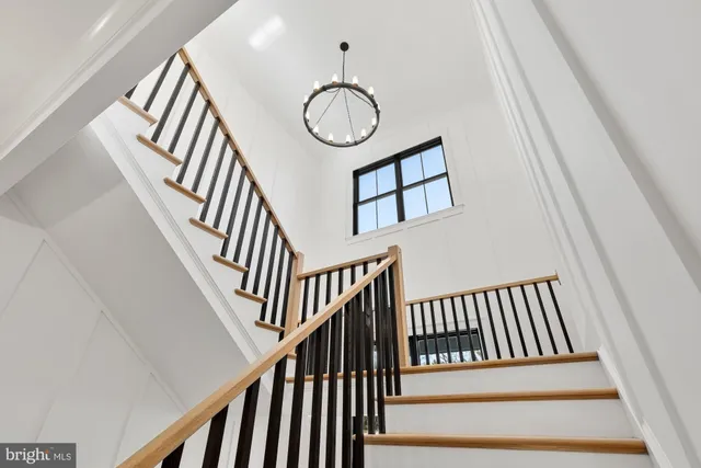 a view of a hallway with wooden floor and front door