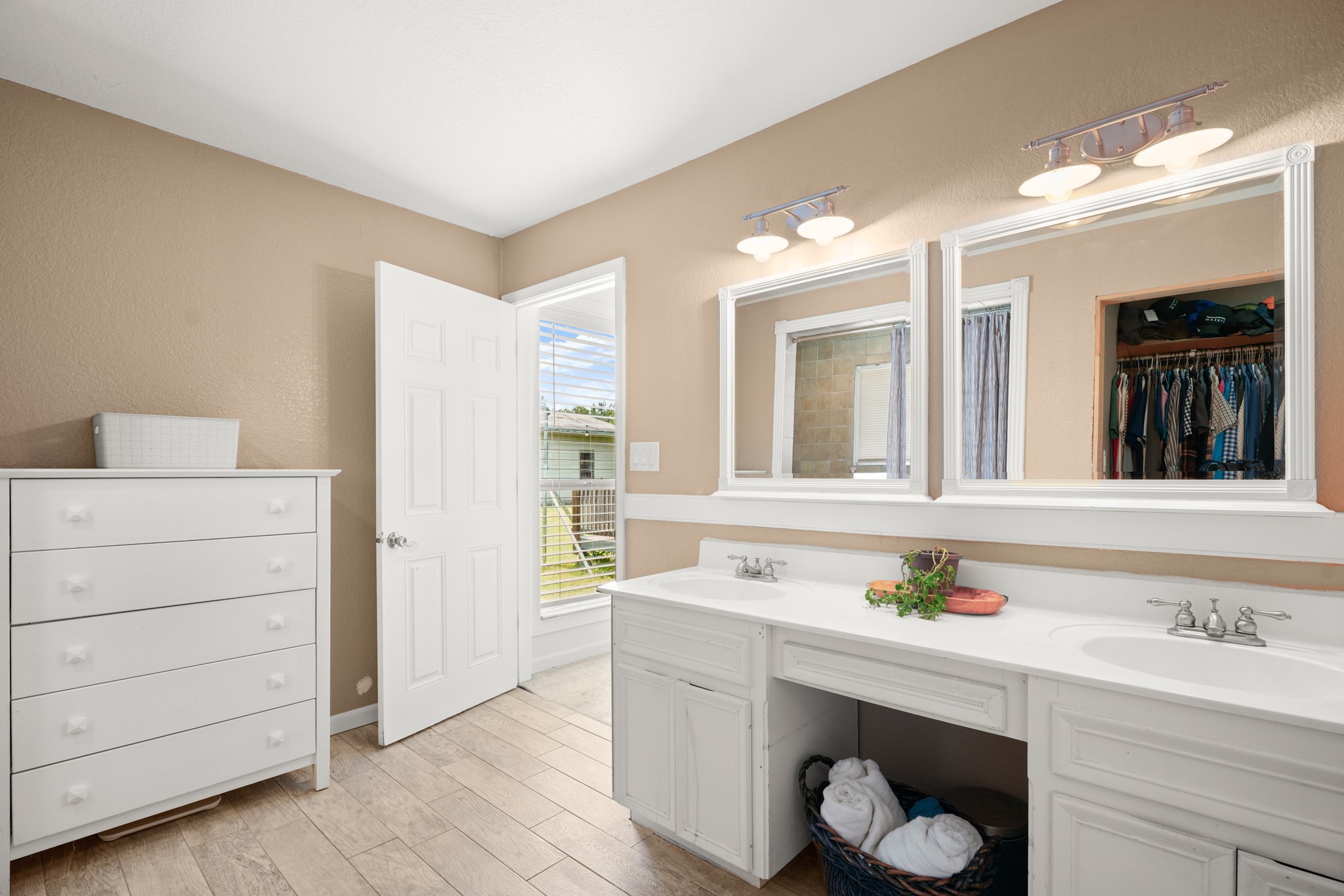9725 Bock Road Buda, TX 78610 - Photo 23 of 32 Dual vanity sinks provide ample space in this well-lit primary bathroom.