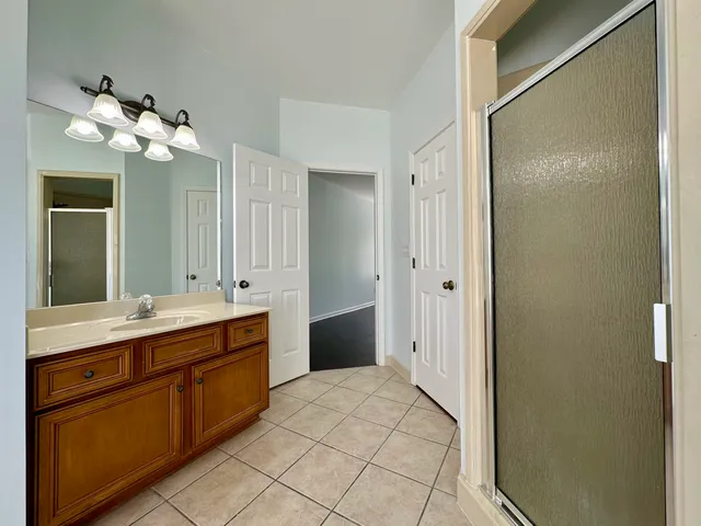a spacious bathroom with a double vanity sink and a mirror