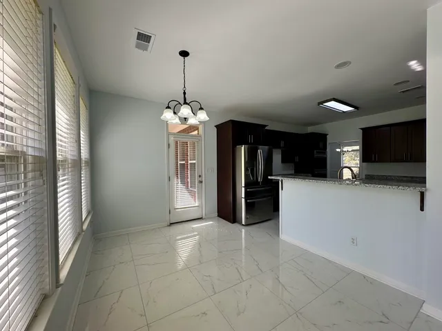 a view of a kitchen with a sink and a refrigerator