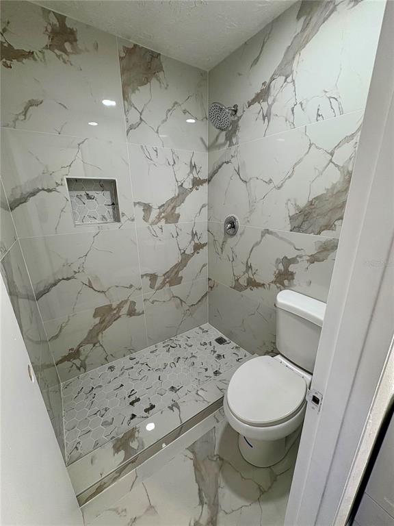 5401 Hansel Avenue, Unit 2 Orlando, FL 32809 - Photo 12 of 25 a white toilet sitting next to a bathroom sink