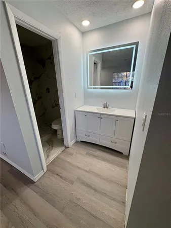 a view of a hallway and closet with mirror