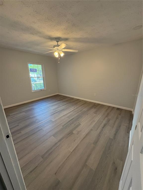 5401 Hansel Avenue, Unit 2 Orlando, FL 32809 - Photo 15 of 25 an empty room with wooden floor and windows