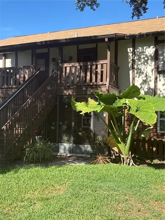 a view of a house with yard and a patio