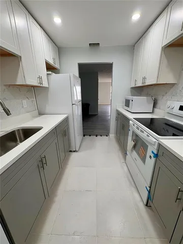 a kitchen that has a sink and a stove