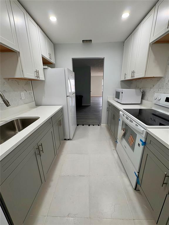 5401 Hansel Avenue, Unit 2 Orlando, FL 32809 - Photo 5 of 25 a kitchen that has a sink and a stove