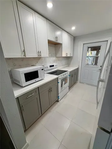 a kitchen with a sink stove and cabinets