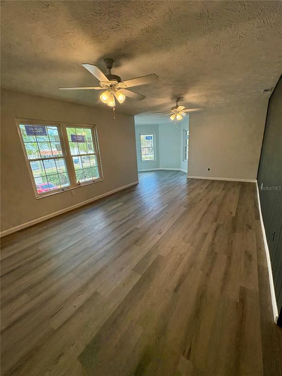 5401 Hansel Avenue, Unit 2 Orlando, FL 32809 - Photo 7 of 25 a view of an empty room with a window and wooden floor