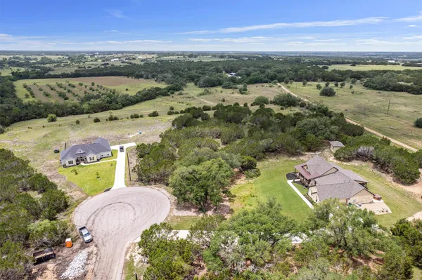 an aerial view of lake and residential houses with outdoor space