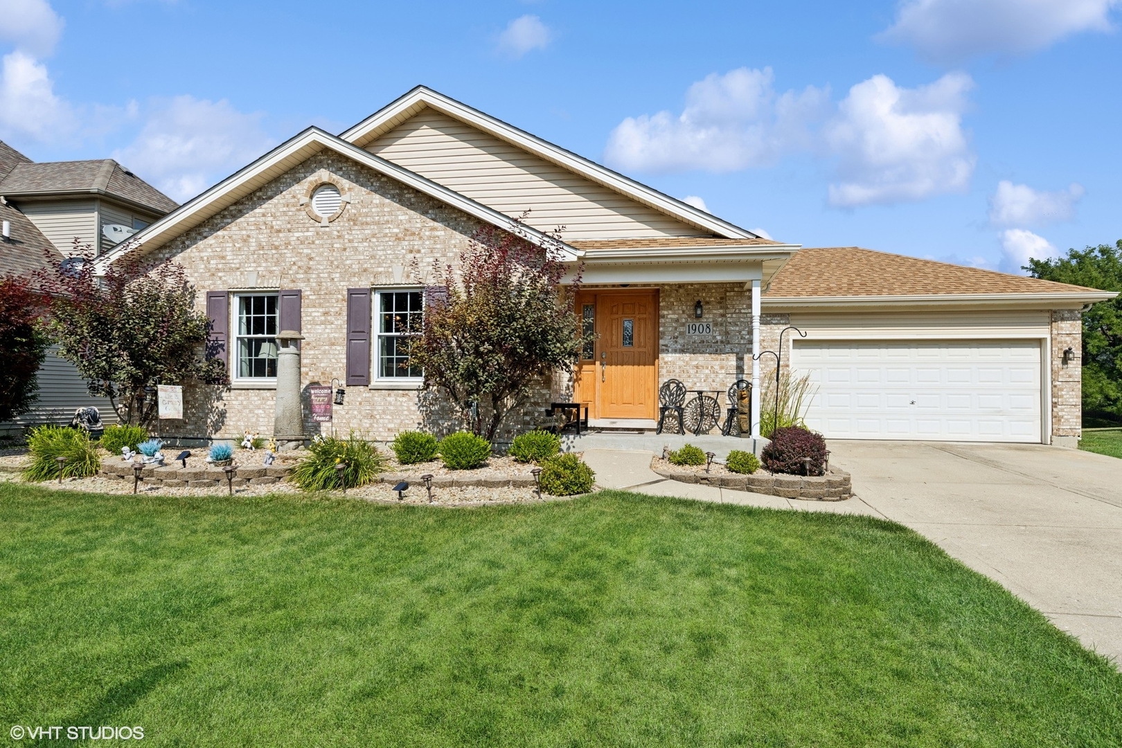 a front view of a house with garden and patio