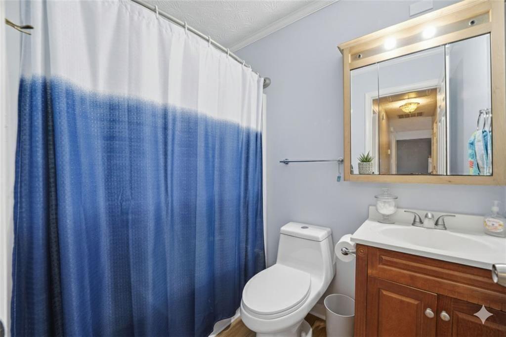 147 Midland Drive Stockbridge, GA 30281 - Photo 12 of 30 a white toilet sitting next to a bathroom sink