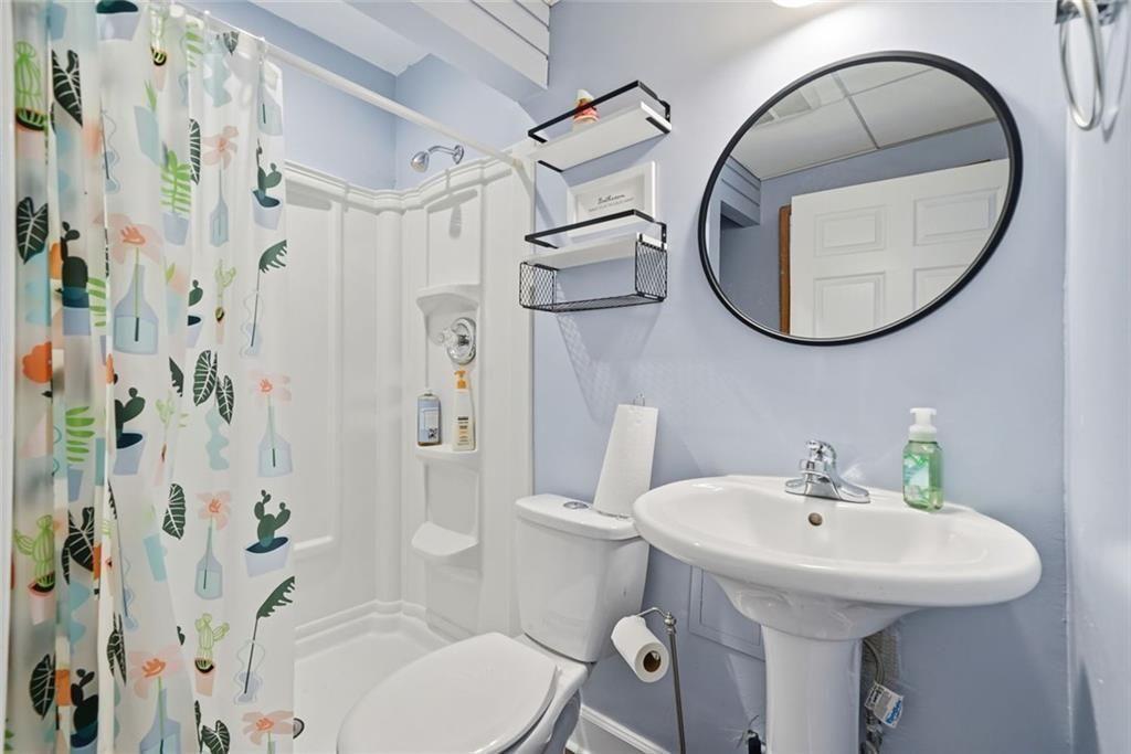 147 Midland Drive Stockbridge, GA 30281 - Photo 17 of 30 a bathroom with a sink a toilet and a mirror