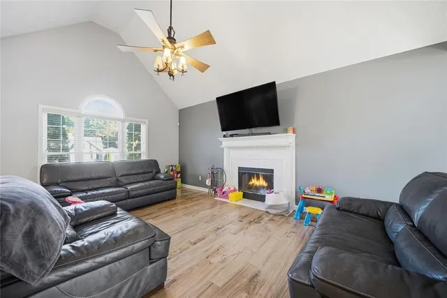 a living room with furniture a fireplace and a flat screen tv
