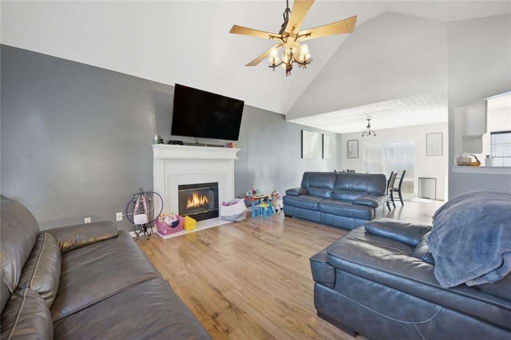 147 Midland Drive Stockbridge, GA 30281 - Photo 4 of 30 a living room with furniture a fireplace and a flat screen tv