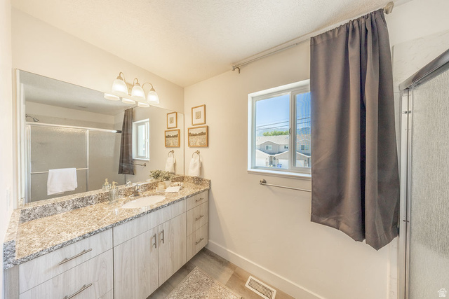 4991 South 475 West Washington Terrace, UT 84405 - Photo 23 of 31 Granite countertop. Large wall mirror. Modern light fixture. Sliding glass doors to shower viewable in mirror.