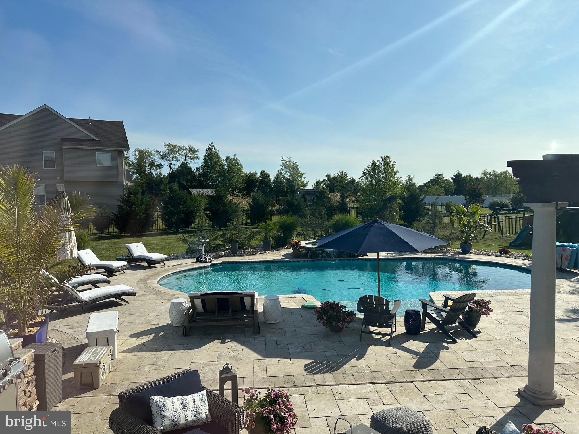 804 Chelsea Glenn Road Clarksboro, NJ 08020 - Photo 50 of 58 a view of a lake with couches under an umbrella