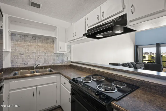 a kitchen with a stove and a sink