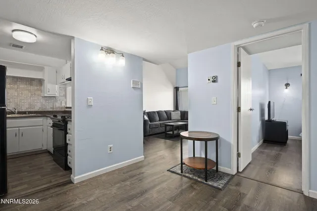 a view of a livingroom with entryway and workspace