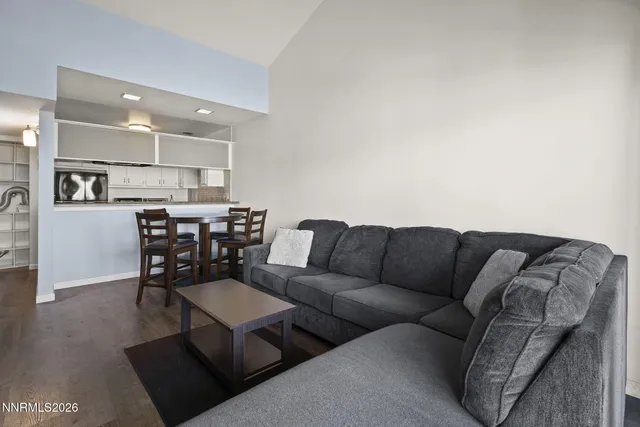 a living room with furniture and kitchen view