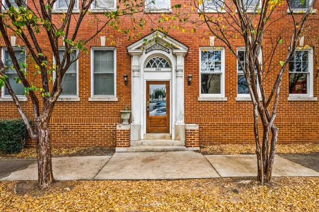 a view of a brick building with many windows