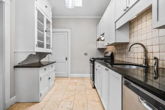 a utility room with sink dryer and washer