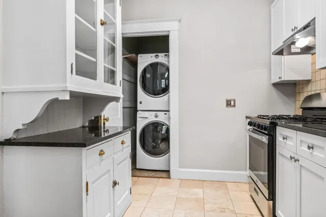 a kitchen with stainless steel appliances granite countertop a stove a refrigerator and a granite counter tops