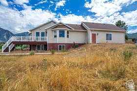 19 East Southfield Road Spanish Fork, UT 84660 - Photo 67 of 74 Rear view of house with a wooden deck and stairway
