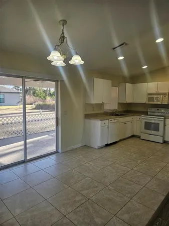 a view of a kitchen with a stove cabinets and a kitchen counter top