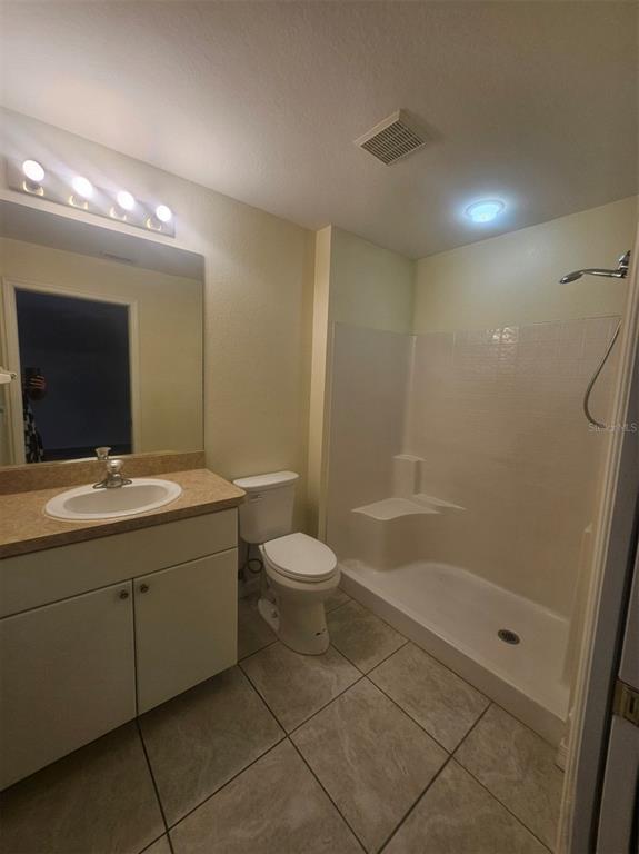 7450 Blutter Road North Port, FL 34291 - Photo 17 of 20 a bathroom with a granite countertop sink a toilet and shower