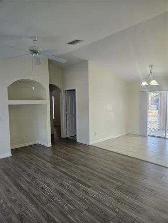 a view of a room with wooden floor and a window