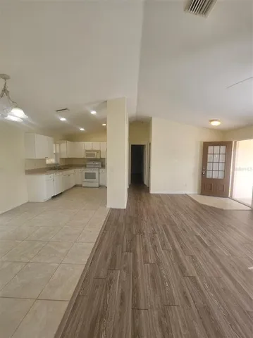 a view of kitchen with kitchen island sink and wooden floor