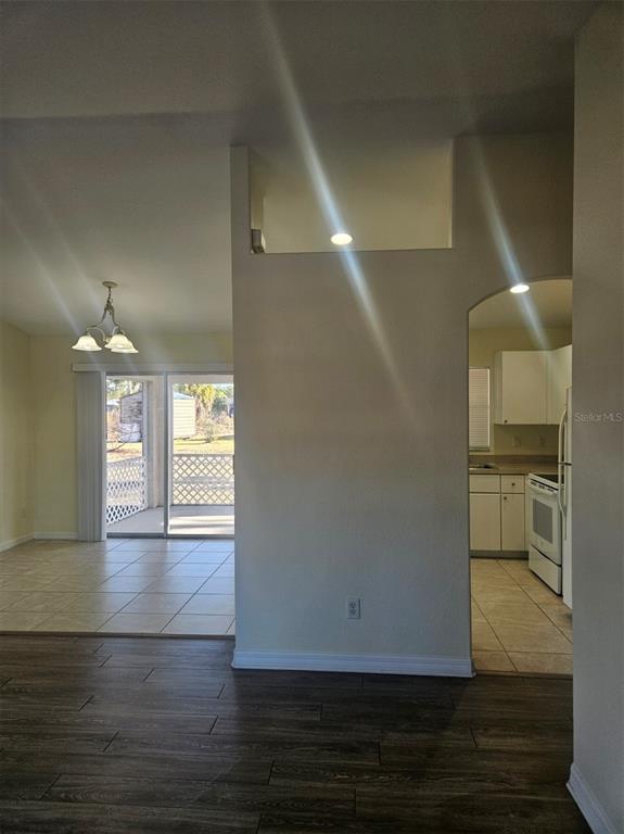 7450 Blutter Road North Port, FL 34291 - Photo 6 of 34 a view of a hallway with wooden floor and a living room
