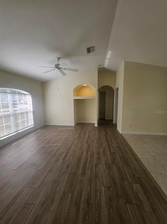 7450 Blutter Road North Port, FL 34291 - Photo 7 of 34 an empty room with wooden floor and windows
