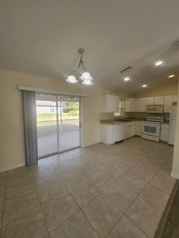 a view of a kitchen with a sink and a window