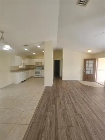 a view of kitchen with kitchen island sink and wooden floor