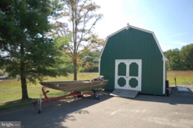 14143 Taylorstown Road Leesburg, VA 20176 - Photo 2 of 15 a backyard of a house with barbeque oven and outdoor seating