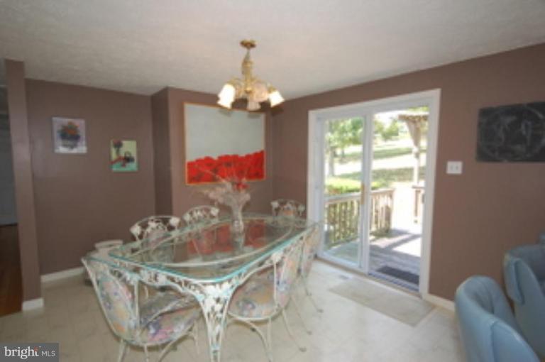 14143 Taylorstown Road Leesburg, VA 20176 - Photo 12 of 15 a dining room with furniture a chandelier and window