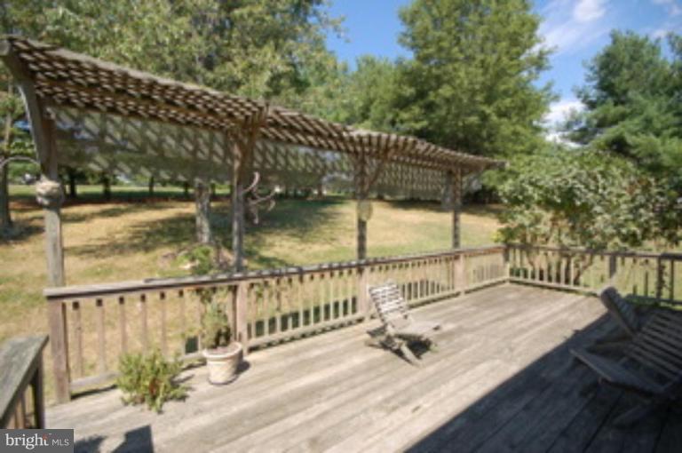14143 Taylorstown Road Leesburg, VA 20176 - Photo 4 of 15 a view of balcony with wooden floor and outdoor seating
