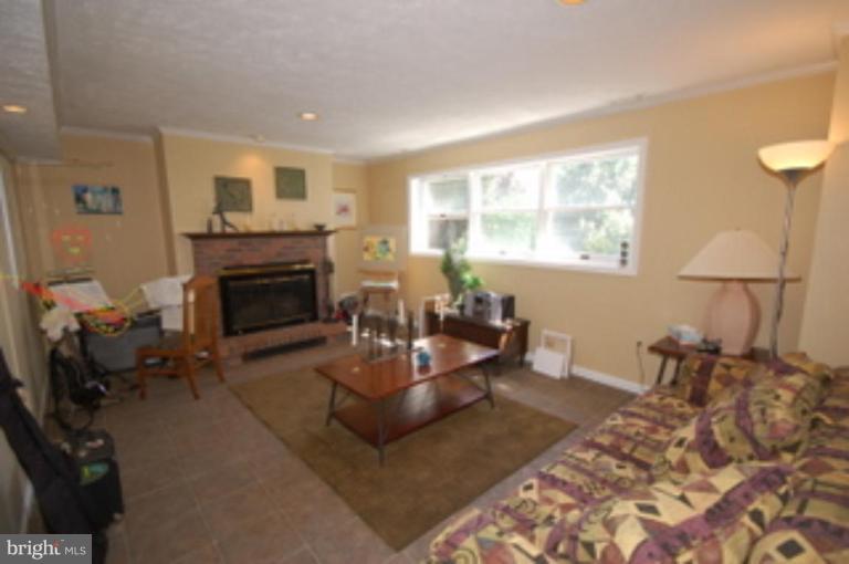 14143 Taylorstown Road Leesburg, VA 20176 - Photo 5 of 15 a living room with furniture and a fireplace