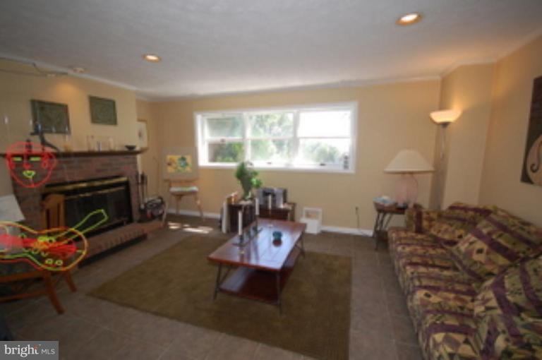 14143 Taylorstown Road Leesburg, VA 20176 - Photo 6 of 15 a living room with furniture and a fireplace
