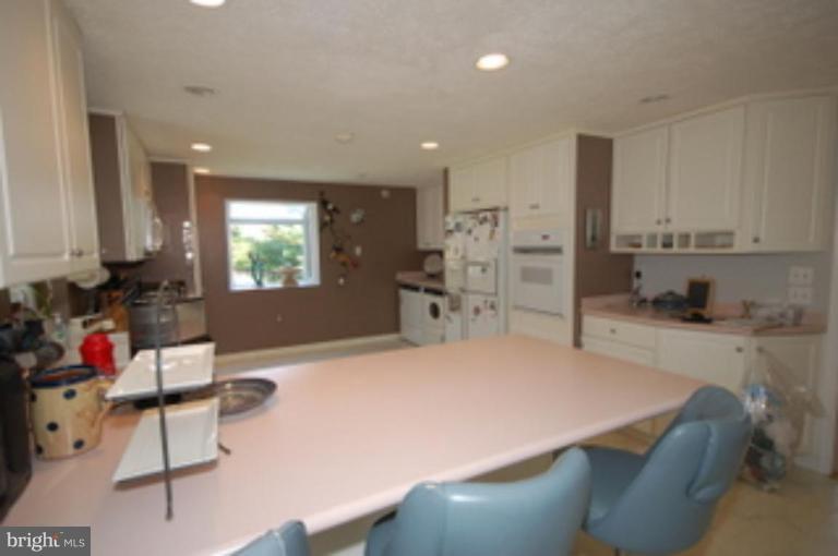 14143 Taylorstown Road Leesburg, VA 20176 - Photo 9 of 15 a kitchen with stainless steel appliances kitchen island granite countertop a sink and cabinets