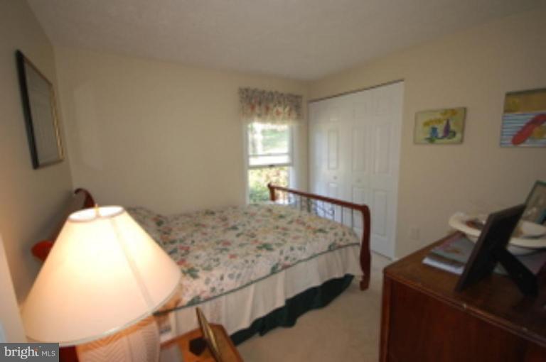 14143 Taylorstown Road Leesburg, VA 20176 - Photo 10 of 15 a bedroom with a bed and wooden floor