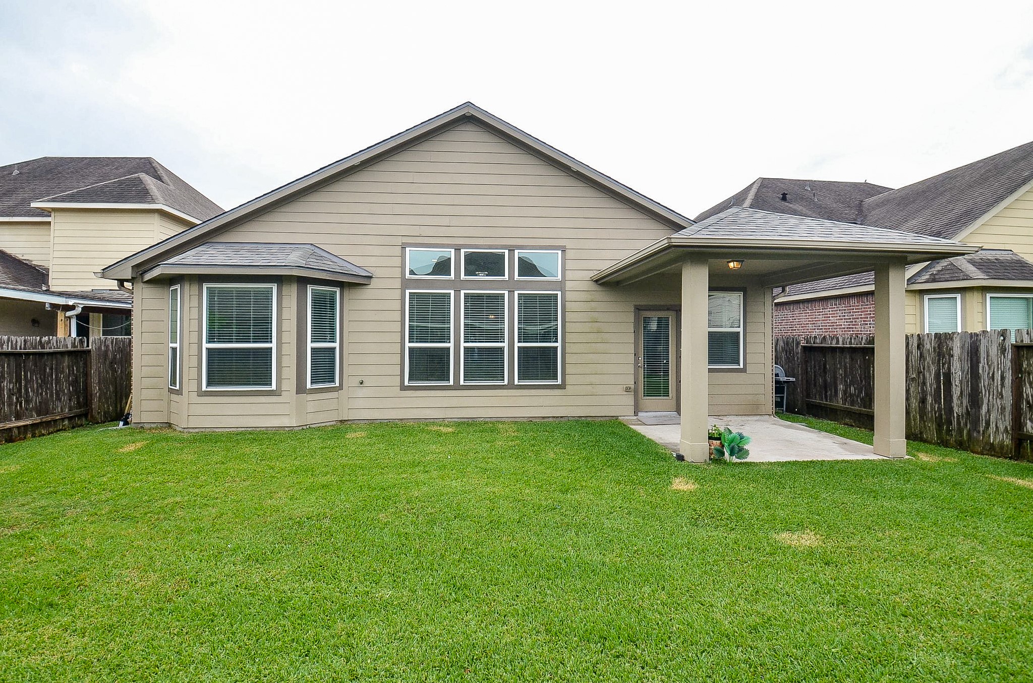 7042 Sliding Rock Circle Spring, TX 77379 - Photo 26 of 36 Inviting Backyard Retreat: Spacious and lush, perfect for relaxation and outdoor gatherings.