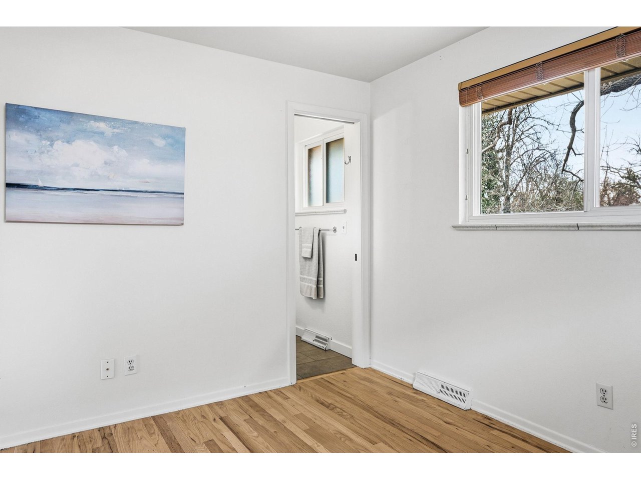 130 Cherokee Way Boulder, CO 80303 - Photo 11 of 25 a view of an empty room with wooden floor and a window