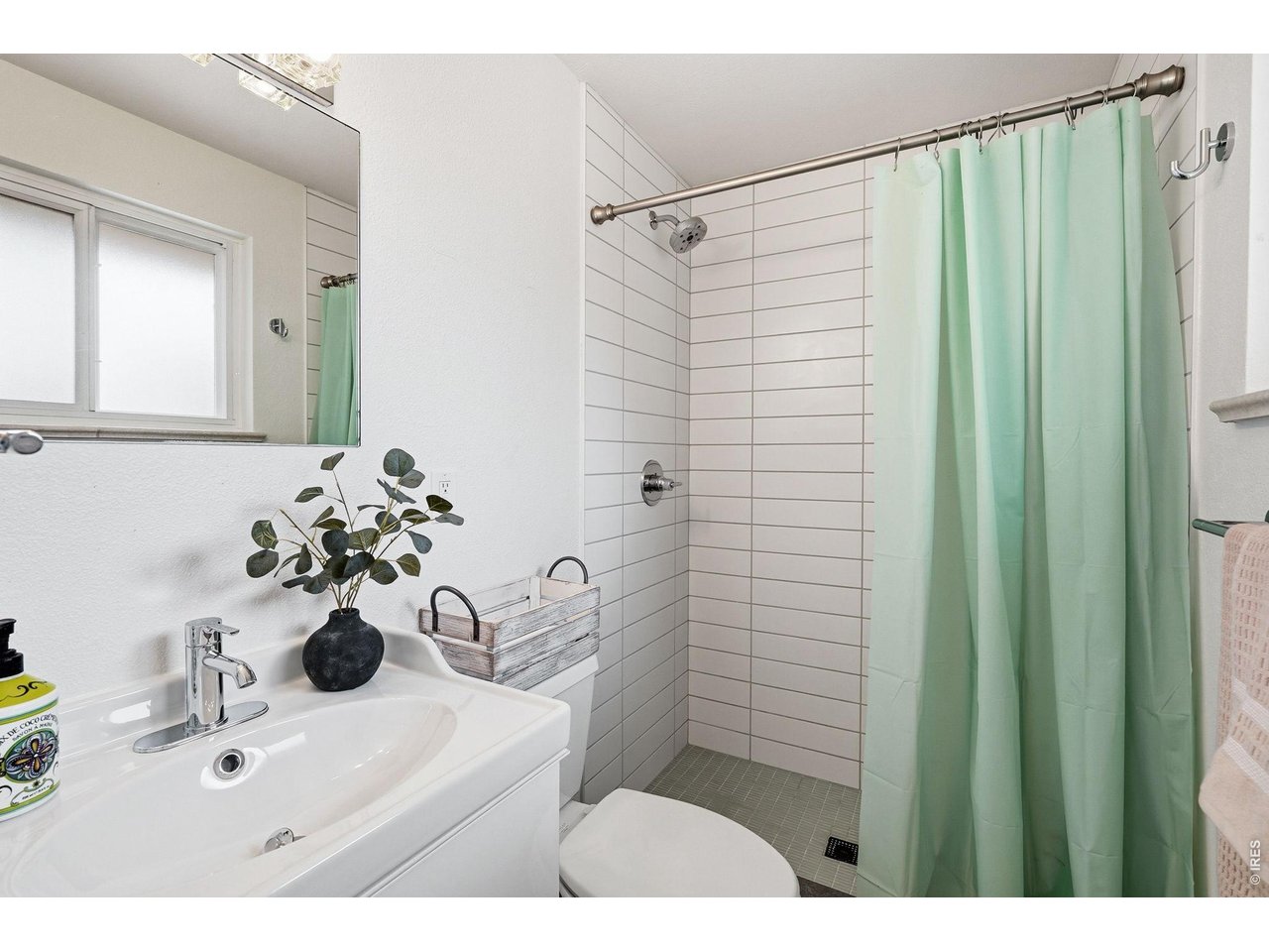 130 Cherokee Way Boulder, CO 80303 - Photo 12 of 25 a bathroom with a sink a mirror and a shower