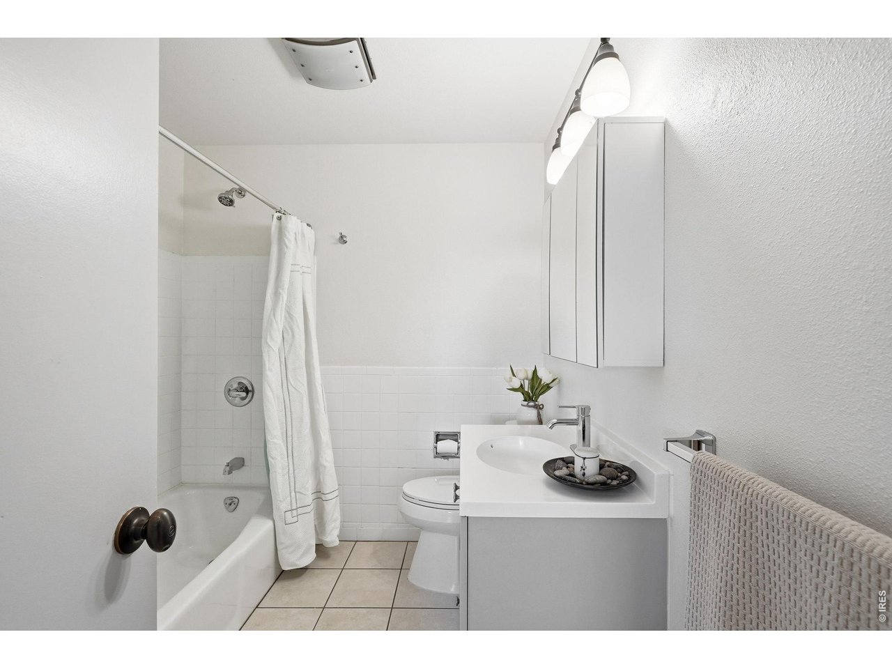 130 Cherokee Way Boulder, CO 80303 - Photo 16 of 25 a bathroom with a sink and mirror with shower