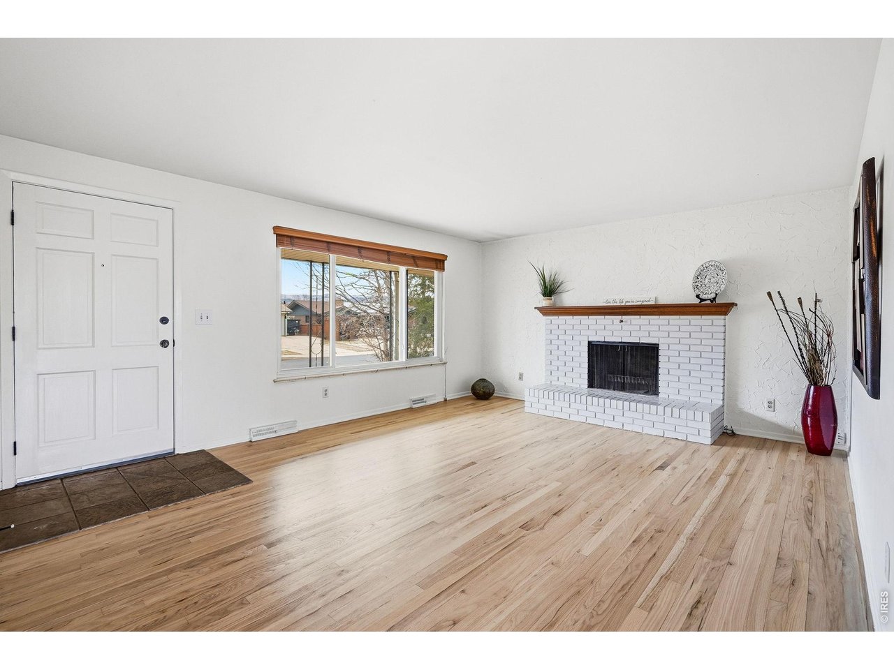 130 Cherokee Way Boulder, CO 80303 - Photo 2 of 25 a view of empty room with wooden floor and fireplace